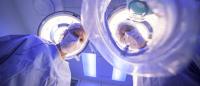 doctor holding an anesthesia mask over a surgical patient